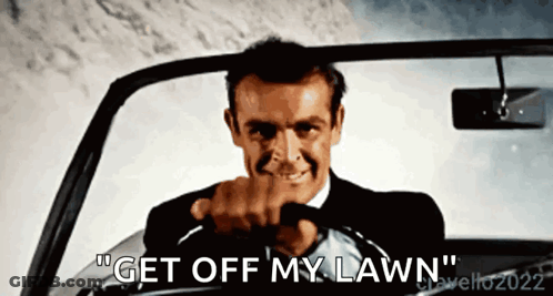 A Man Driving A Car With The Words " Get Off My Lawn " Written On The Bottom GIF