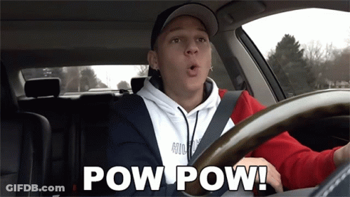 A Man Driving A Car With The Words Pow Pow Written On The Screen GIF