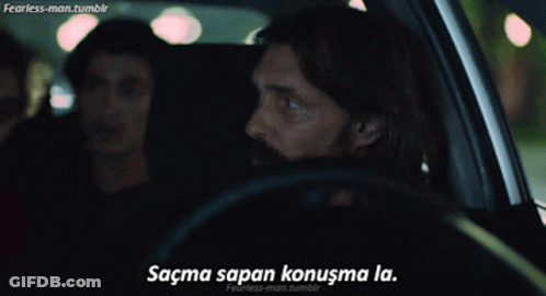 A Man Driving A Car With The Words " Sacma Sapan Konuşma La " On The Bottom Right GIF