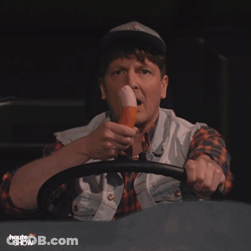 A Man Driving A Vehicle With The Words Heute Show On The Bottom Left GIF