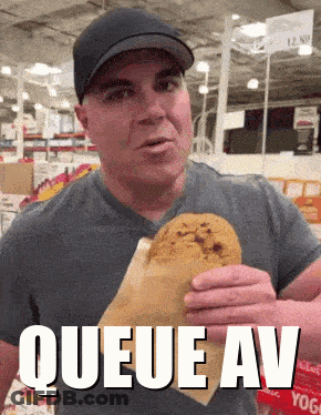 A Man Eating A Cookie With The Words Queue Av Written Above Him GIF