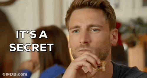 A Man Eating A Piece Of Food With The Words " It 'S A Secret " Written Above Him GIF