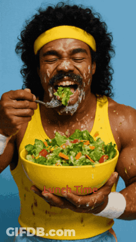 A Man Eating A Salad With Lunch Time Written On The Bottom Right GIF
