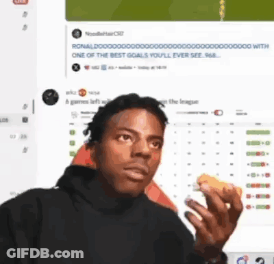 A Man Eating A Sandwich In Front Of A Computer Screen . GIF