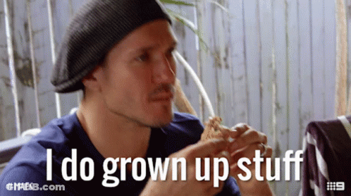 A Man Eating A Sandwich With The Words " I Do Grown Up Stuff " Behind Him GIF