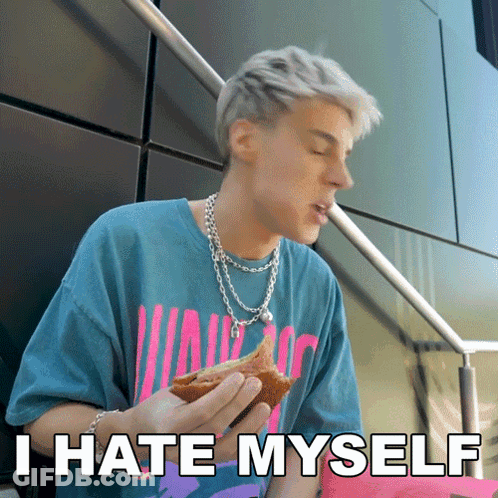 A Man Eating A Sandwich With The Words " I Hate Myself " On The Bottom GIF