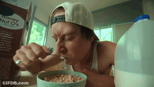 A Man Eats Honey Nut O 'S Cereal From A Bowl GIF
