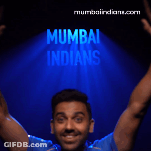 A Man Flexes His Muscles In Front Of A Mumbai Indians Logo GIF