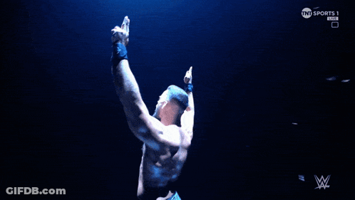 A Man Flexes His Muscles In Front Of A Screen That Says Tnt Sports GIF