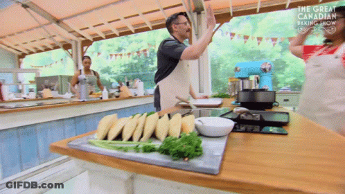 A Man Giving A High Five In A Kitchen With The Words The Great Canadian Baking Show On The Bottom GIF