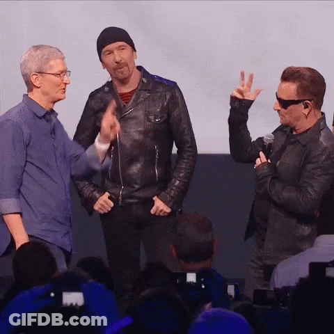A Man Giving A Peace Sign While Standing Next To Two Other Men GIF