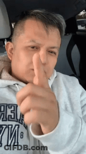 A Man Giving A Thumbs Up In A Car While Wearing A Sweatshirt That Says Abercrombie & Fitch GIF
