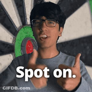 A Man Giving A Thumbs Up In Front Of A Dart Board With The Words Spot On GIF