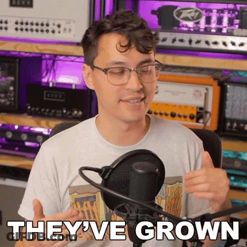 A Man Giving A Thumbs Up In Front Of A Microphone With The Words " They 'Ve Grown " Above Him GIF
