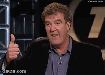 A Man Giving A Thumbs Up In Front Of A Sign That Says 7 GIF