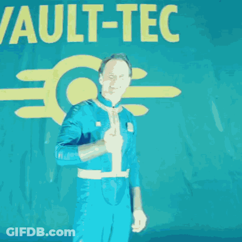 A Man Giving A Thumbs Up In Front Of A Sign That Says Vault-C GIF