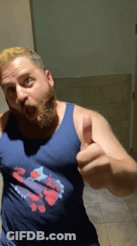 A Man Giving A Thumbs Up Wearing A Blue Tank Top GIF