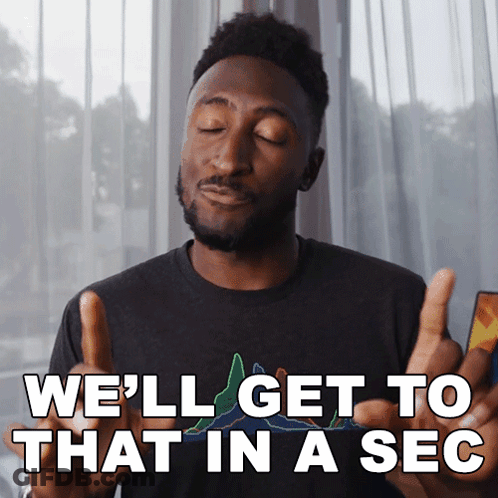 A Man Giving A Thumbs Up With The Words We 'Ll Get To That In A Sec Below Him GIF