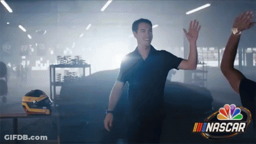 A Man Giving Another Man A High Five In A Nascar Ad GIF