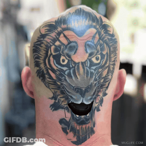 A Man Has A Tattoo Of A Lion On His Head And Neck GIF