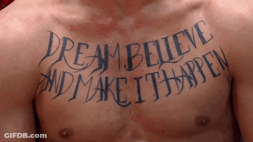 A Man Has A Tattoo On His Chest That Reads " Dream Believe And Make It Happen " GIF
