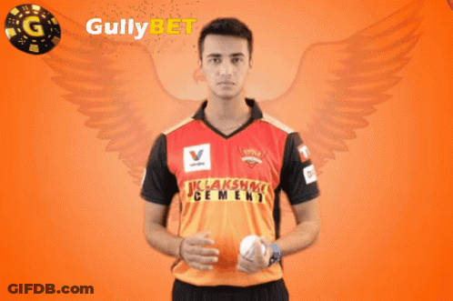 A Man Holding A Ball In Front Of Gullybet GIF