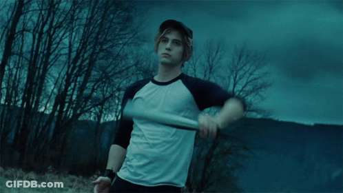 A Man Holding A Baseball Bat In A Field GIF