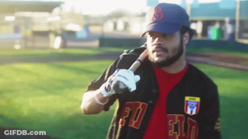 A Man Holding A Baseball Bat With The Letter B On The Hat GIF