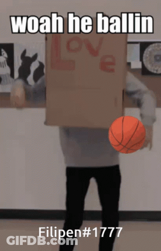 A Man Holding A Basketball In Front Of A Cardboard Box That Says Love GIF