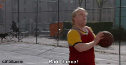 A Man Holding A Basketball On A Court With The Words Rain Dance Above Him GIF