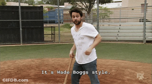 A Man Holding A Bat With The Words It 'S Wade Boggs Style Below Him GIF