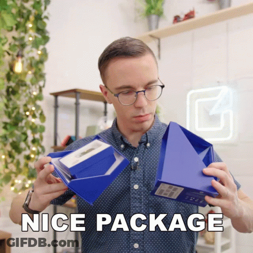 A Man Holding A Blue Box That Says Nice Package On The Bottom GIF