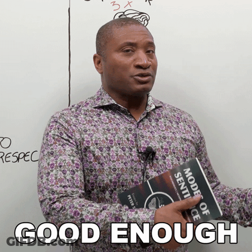 A Man Holding A Book That Says " Good Enough " On It GIF