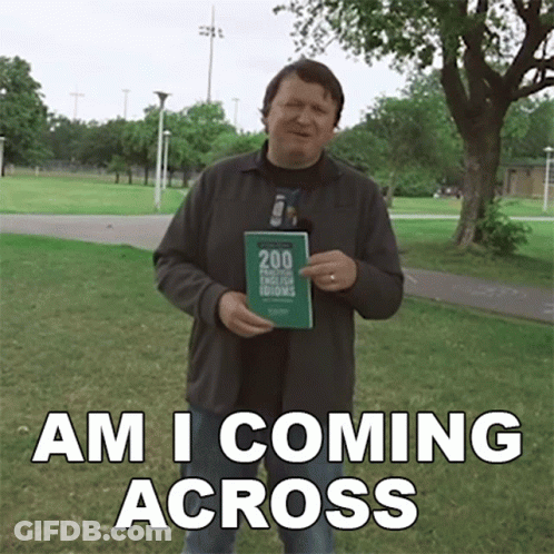 A Man Holding A Book With The Words Am I Coming Across GIF