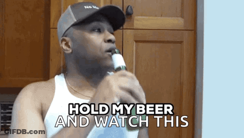 A Man Holding A Bottle Of Beer With The Words Hold My Beer And Watch This Below Him GIF