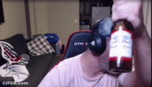 A Man Holding A Bottle Of Budweiser In Front Of His Face . GIF