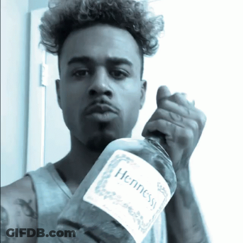 A Man Holding A Bottle Of Hennessy In His Hand GIF