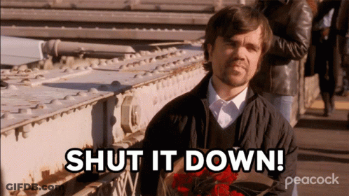 A Man Holding A Bouquet Of Red Roses With The Words Shut It Down Behind Him GIF