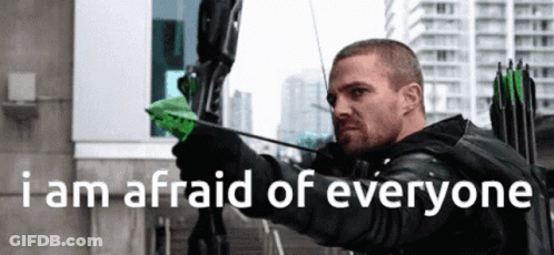 A Man Holding A Bow And Arrow With The Words " I Am Afraid Of Everyone " Below Him GIF