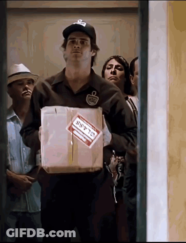 A Man Holding A Box With A Label That Says Ssfts GIF