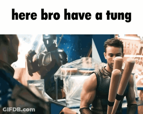 A Man Holding A Bunch Of Baseball Bats With The Words Here Bro Have A Tung Below Him GIF