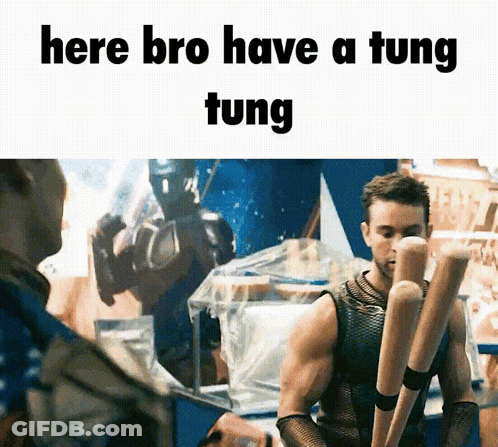 A Man Holding A Bunch Of Baseball Bats With The Words Here Bro Have A Tung Tung GIF