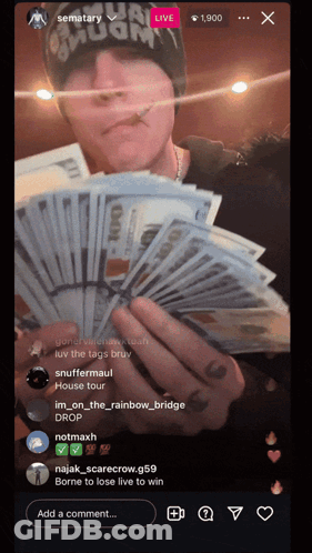 A Man Holding A Bunch Of Money In Front Of A Screen That Says Sematary GIF