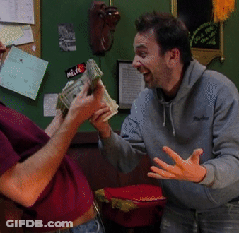 A Man Holding A Bunch Of Money With A Sticker That Says Mette GIF