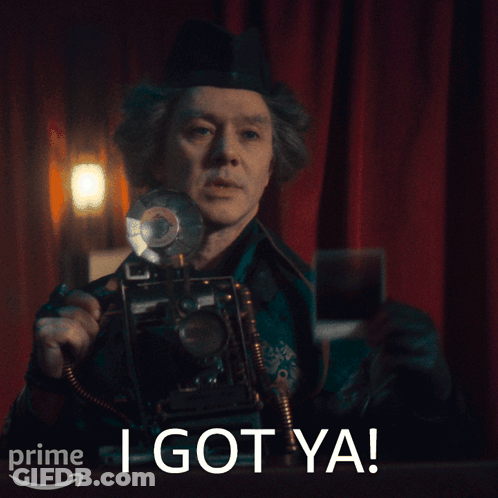A Man Holding A Camera With The Words I Got Ya On The Bottom Right GIF