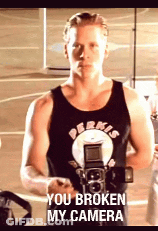 A Man Holding A Camera With The Words You Broken My Camera Written On The Bottom GIF