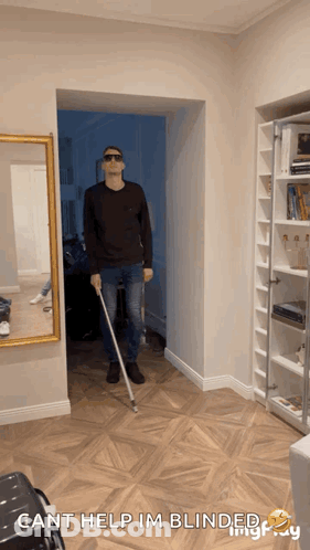 A Man Holding A Cane In A Hallway With The Words Cant Help Im Blinded GIF