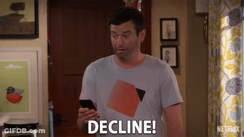 A Man Holding A Cell Phone With The Word Decline On His Shirt GIF