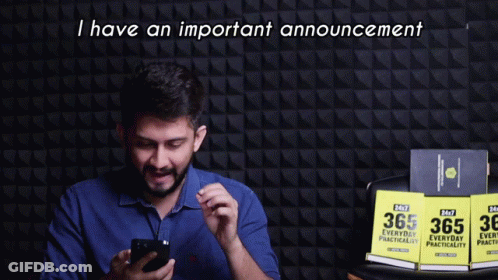 A Man Holding A Cell Phone With The Words I Have An Important Announcement Behind Him GIF