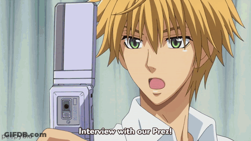A Man Holding A Cell Phone With The Words Interview With Our Prez Written Below Him GIF